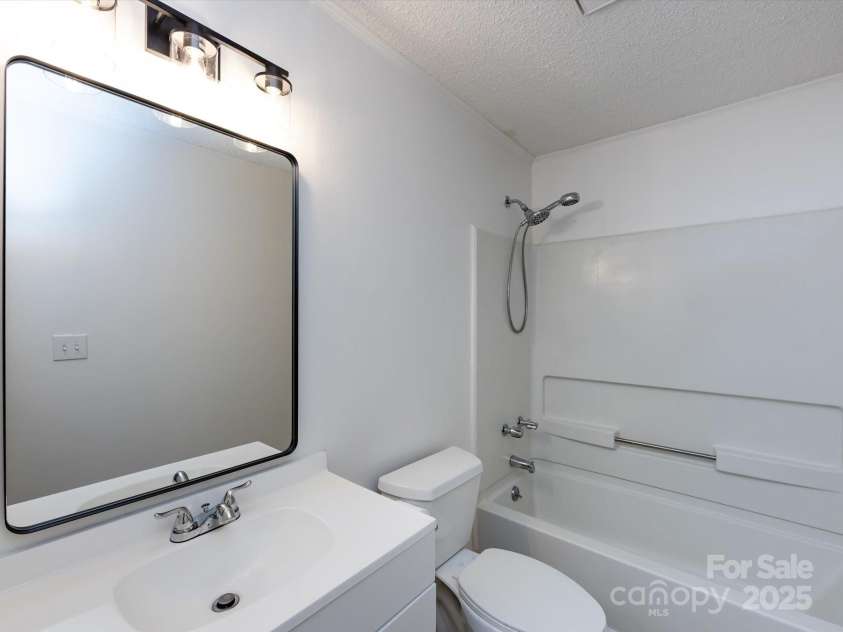 7960 Tiburon Circle, Charlotte, NC 28215.  MLS# CAR4276761, YatesRealty ID 23690. Guest bathroom with updated mirror and lighting.