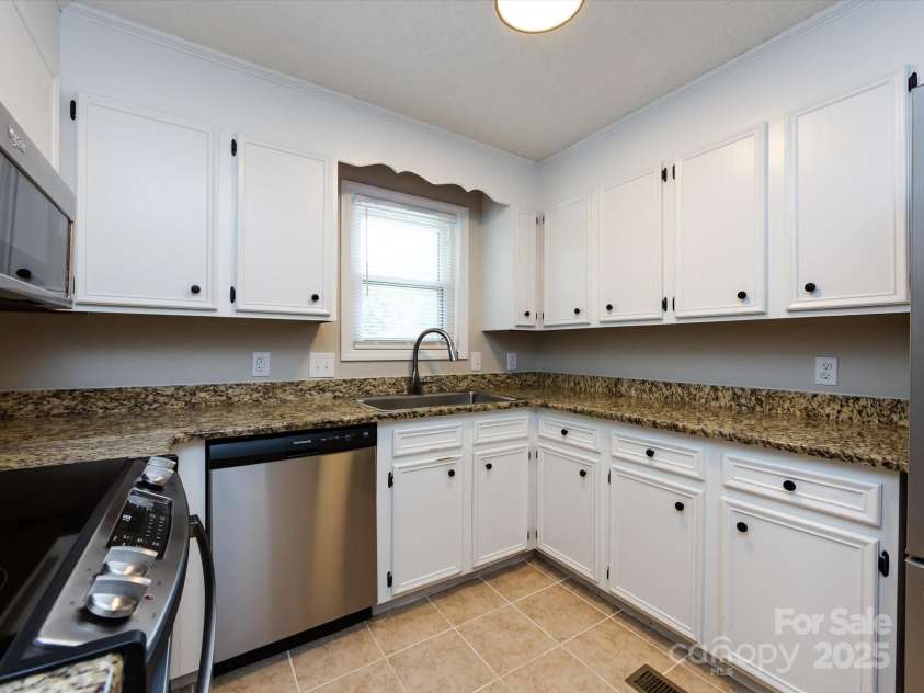 7960 Tiburon Circle, Charlotte, NC 28215.  MLS# CAR4276761, YatesRealty ID 23690. Lots of counter space and painted white cabinets.