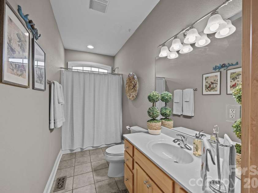 43 Smokemont Drive, Arden, NC 28704.  MLS# CAR4383229, YatesRealty ID 23718. The bath between the main level secondary bedrooms.