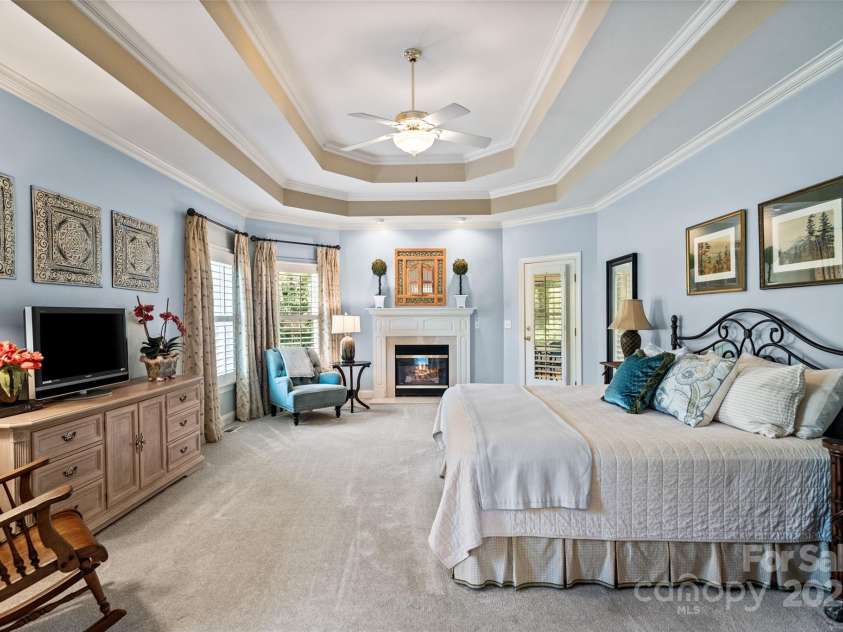 9027 Kirkley Court, Charlotte, NC 28277.  MLS# CAR4271257, YatesRealty ID 23728. Main Floor Primary Bedroom with Fireplace and Private Entrance to Screened Porch