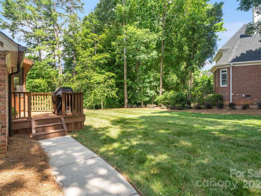 9027 Kirkley Court, Charlotte, NC 28277.  MLS# CAR4271257, YatesRealty ID 23728. Walkway from garage/driveway to backyard - inground basketball hoop