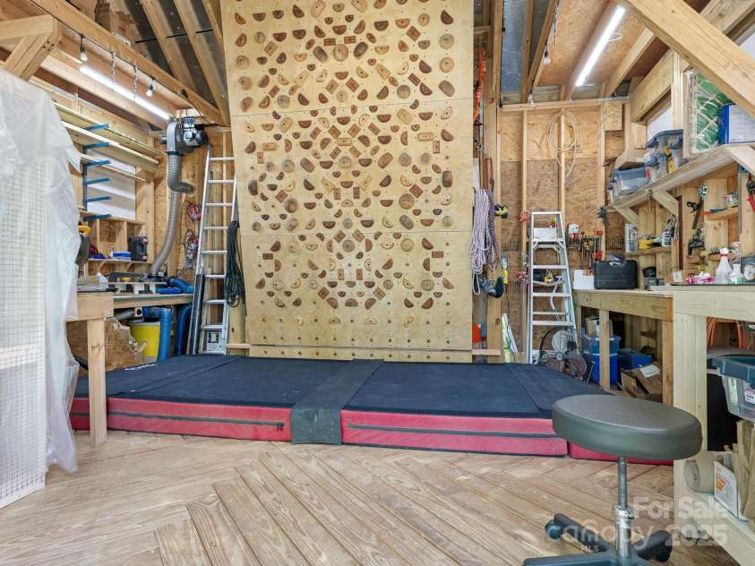 2410 Vernon Drive, Charlotte, NC 28211.  MLS# CAR4257447, YatesRealty ID 23739. Interior Shed with Climbing Wall and Carpentry Space