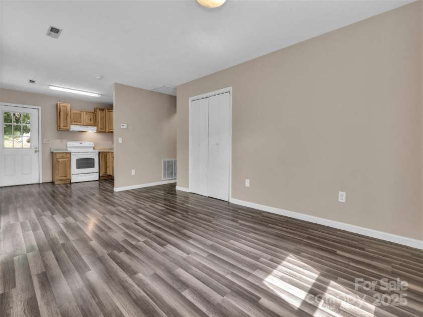 114 Elden Street, Hendersonville, NC 28739.  MLS# CAR4270010, YatesRealty ID 23743. Main level kitchen and living room