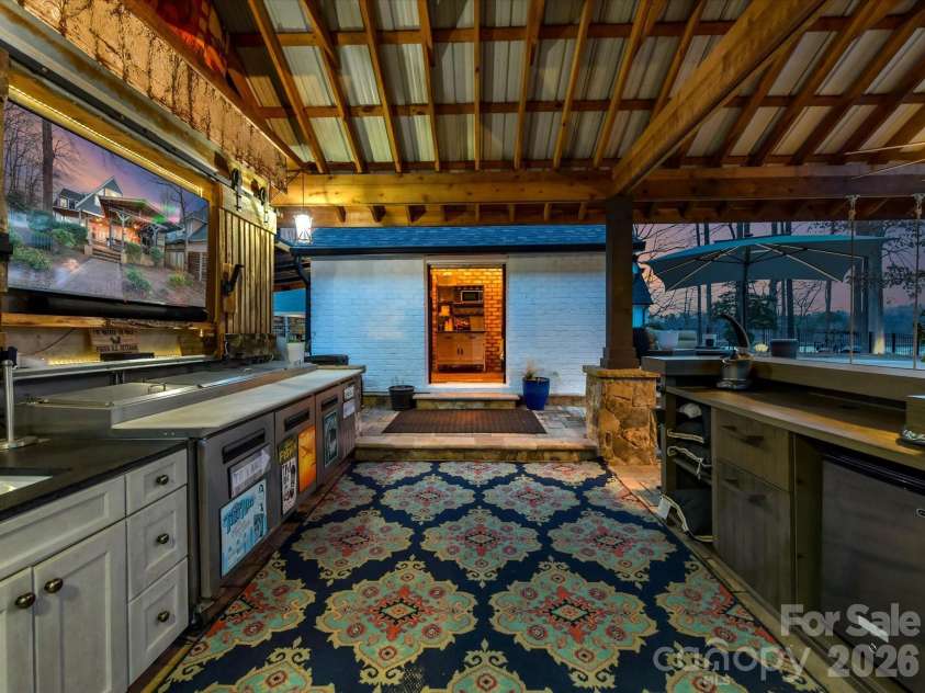 5401 Mountain Point Lane, Charlotte, NC 28216.  MLS# CAR4341424, YatesRealty ID 23753. Poolside Kitchen and television facing Glamping Cabana