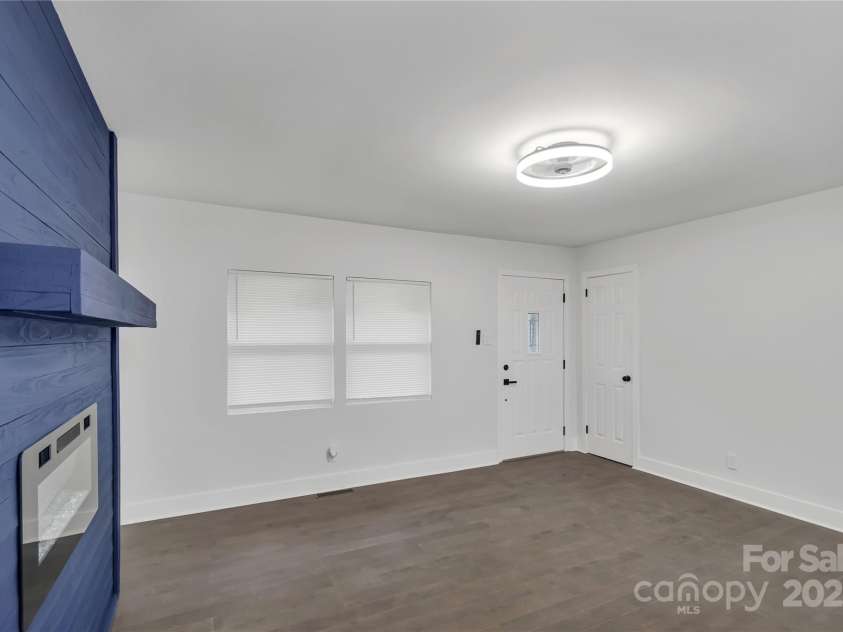 1814 Eastway Drive, Charlotte, NC 28205.  MLS# CAR4239962, YatesRealty ID 23758. Family room w/view of electric fireplace and entrance
