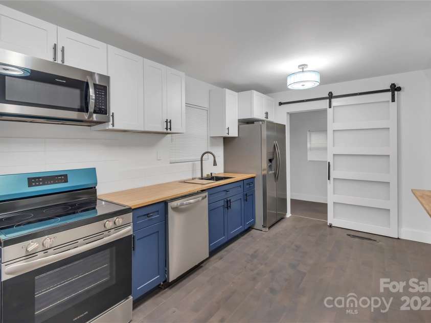1814 Eastway Drive, Charlotte, NC 28205.  MLS# CAR4239962, YatesRealty ID 23758. Kitchen w/view of flex room barn door