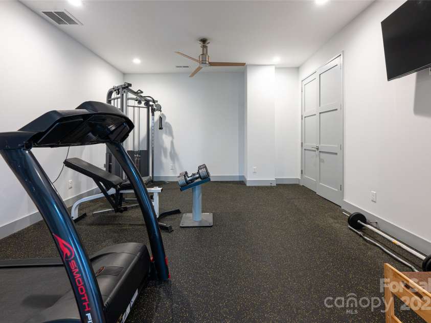 42 Towering Oaks Lane, Asheville, NC 28805.  MLS# CAR4334272, YatesRealty ID 2376. Lower Level gym