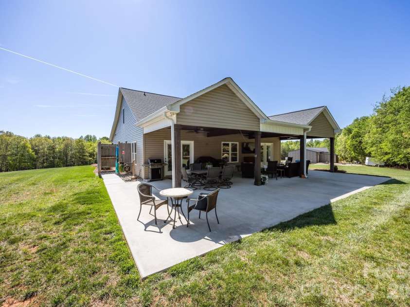 147 Haystack Lane, Olin, NC 28660.  MLS# CAR4375441, YatesRealty ID 23772. Extended patio off the covered section - room for everyone here.