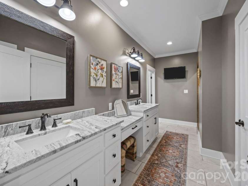 147 Haystack Lane, Olin, NC 28660.  MLS# CAR4375441, YatesRealty ID 23772. Luxurious Primary Bathroom with dressing vanity.