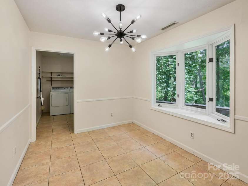 8 Mayfair Drive, Candler, NC 28715.  MLS# CAR4273573, YatesRealty ID 23775. Dining area to laundry