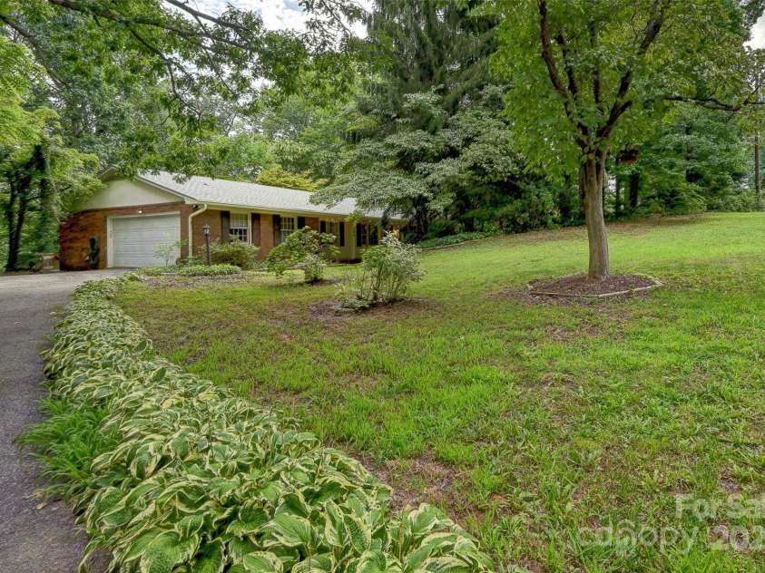 8 Mayfair Drive, Candler, NC 28715.  MLS# CAR4273573, YatesRealty ID 23775. Long flat driveway contributes to privacy