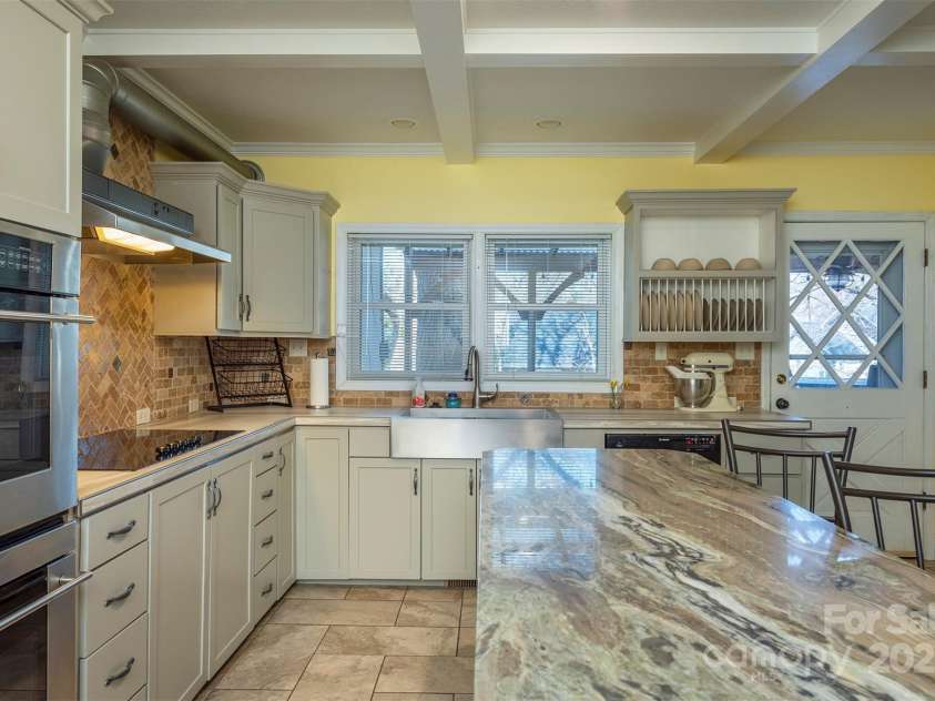 1740 Haywood Road, Hendersonville, NC 28791.  MLS# CAR4226897, YatesRealty ID 2378. Kitchen features a double oven, large breakfast bar, and plenty of space, perfect for accommodating multiple cooks and guests.