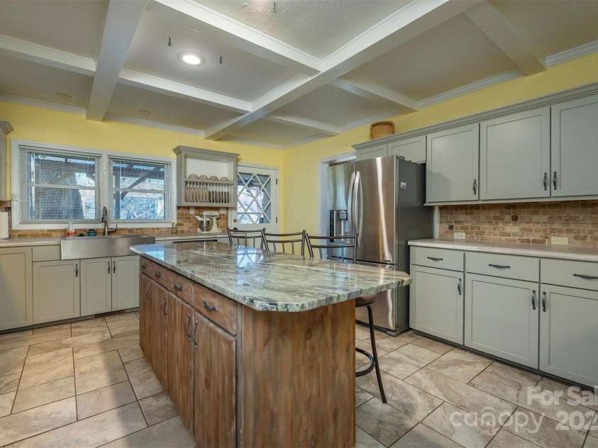 1740 Haywood Road, Hendersonville, NC 28791.  MLS# CAR4226897, YatesRealty ID 2378. Kitchen opens to a covered deck, extending your living space and offering easy access to outdoor entertaining.