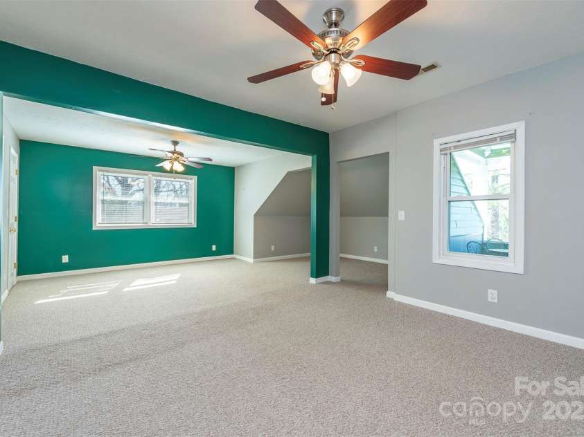 1740 Haywood Road, Hendersonville, NC 28791.  MLS# CAR4226897, YatesRealty ID 2378. Large 6th ensuite bedroom with access to the covered front porch, providing a peaceful retreat and outdoor access