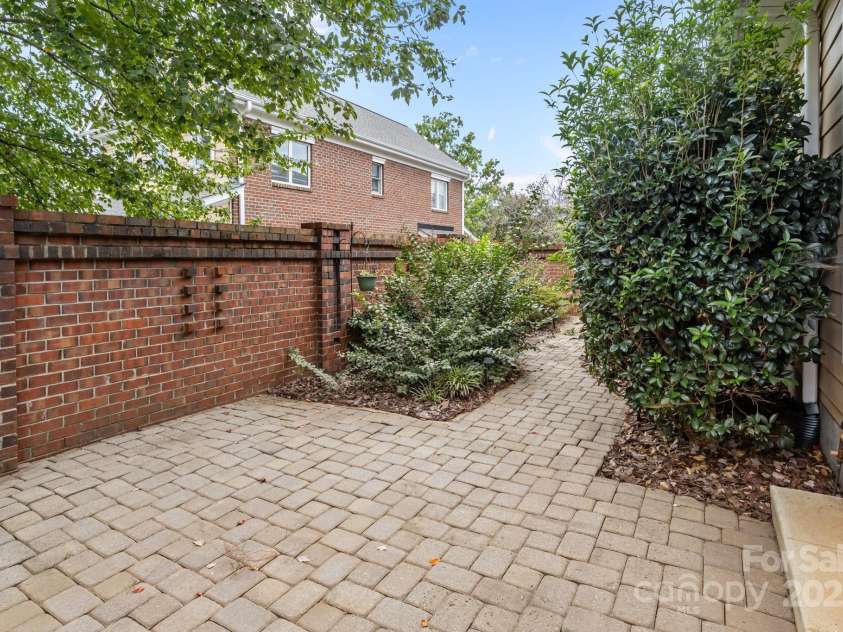 20015 Cove Road, Cornelius, NC 28031.  MLS# CAR4308497, YatesRealty ID 23784. Private brick courtyard offers a peaceful outdoor retreat, perfect for relaxing or entertaining