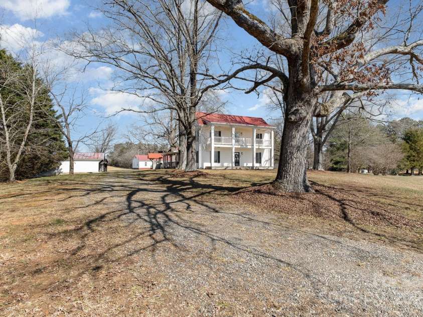 202 Deitz Road, Statesville, NC 28625.  MLS# CAR4220770, YatesRealty ID 2380. Beautiful farmhouse sits among the old oak trees.