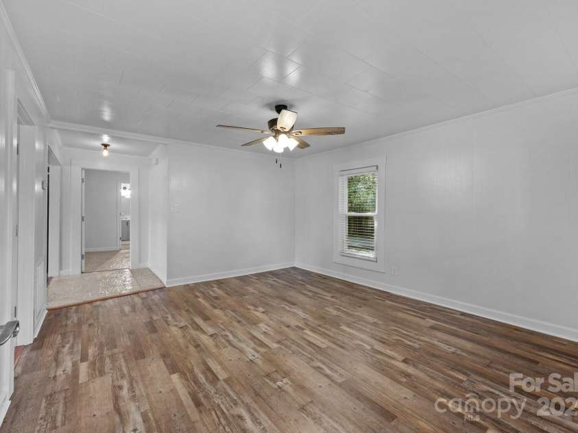 28419 NC Hwy 73 Highway, Albemarle, NC 28001.  MLS# CAR4226158, YatesRealty ID 23808. Looking in from front door to living area. Master straight ahead, second bed to the left.