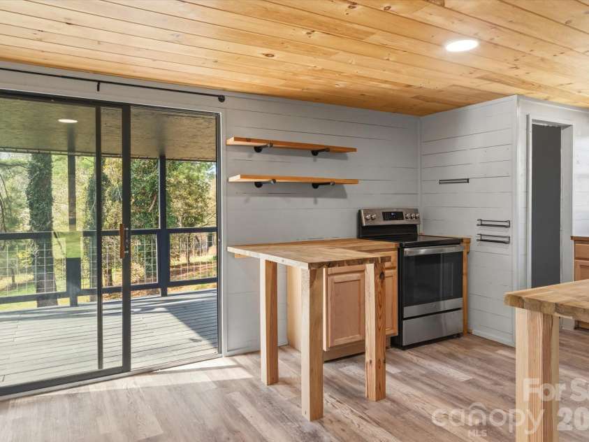 75 Old Macedonia Road, Alexander, NC 28701.  MLS# CAR4364302, YatesRealty ID 23812. Kitchen with deck access