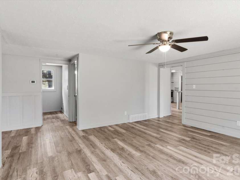 75 Old Macedonia Road, Alexander, NC 28701.  MLS# CAR4364302, YatesRealty ID 23812. Living room looking into laundry room