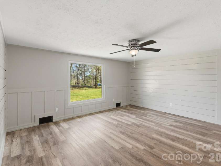 75 Old Macedonia Road, Alexander, NC 28701.  MLS# CAR4364302, YatesRealty ID 23812. Living room w/ large bay window