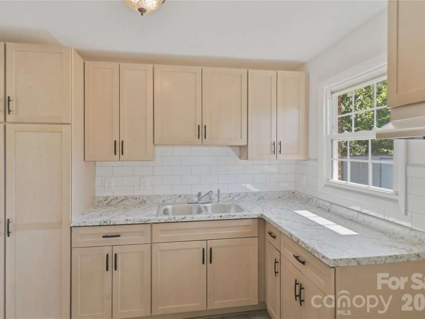 1102 12th Street, Bessemer City, NC 28016.  MLS# CAR4382714, YatesRealty ID 23820. Storage is never an issue in this beautifully redesigned kitchen, which features a massive, double-cabinet-door pantry that is a home organizer's dream. Behind the wide double doors, you will find deep, built-in shelv