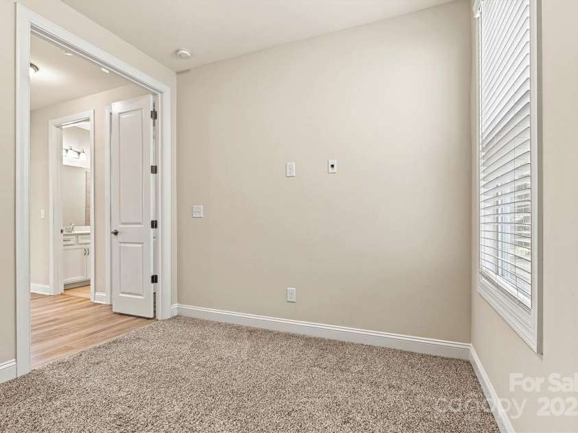 7315 Surprise Court, Charlotte, NC 28215.  MLS# CAR4276101, YatesRealty ID 23823. Bedroom 3 offers privacy with French doors—making it ideal as a guest room, office, or flex space.