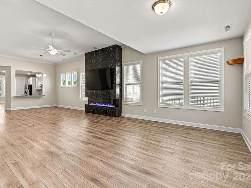 7315 Surprise Court, Charlotte, NC 28215.  MLS# CAR4276101, YatesRealty ID 23823. Low maintenance EVP flooring flows seamlessly through all of the main living areas.