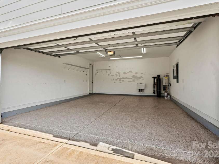 7315 Surprise Court, Charlotte, NC 28215.  MLS# CAR4276101, YatesRealty ID 23823. Oversized garage with epoxy floors and upgraded lighting—perfect for projects or hobbies.