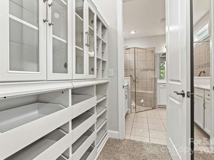 7315 Surprise Court, Charlotte, NC 28215.  MLS# CAR4276101, YatesRealty ID 23823. Two closets in the Primary ensuite, complete with added shelving systems, provide plenty of organized storage space.