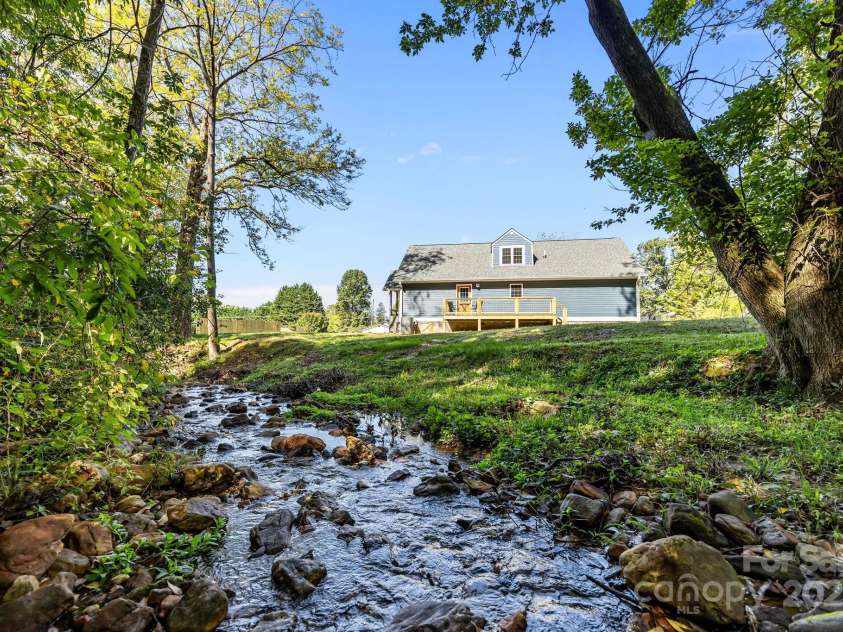 215 McCoy Cove, Black Mountain, NC 28711.  MLS# CAR4333033, YatesRealty ID 2383. Lovely creek and flat yard