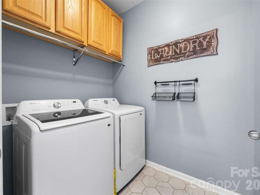 1521 Deer Meadows Drive, Waxhaw, NC 28173.  MLS# CAR4367982, YatesRealty ID 23831. Main level laundry w/cabinets