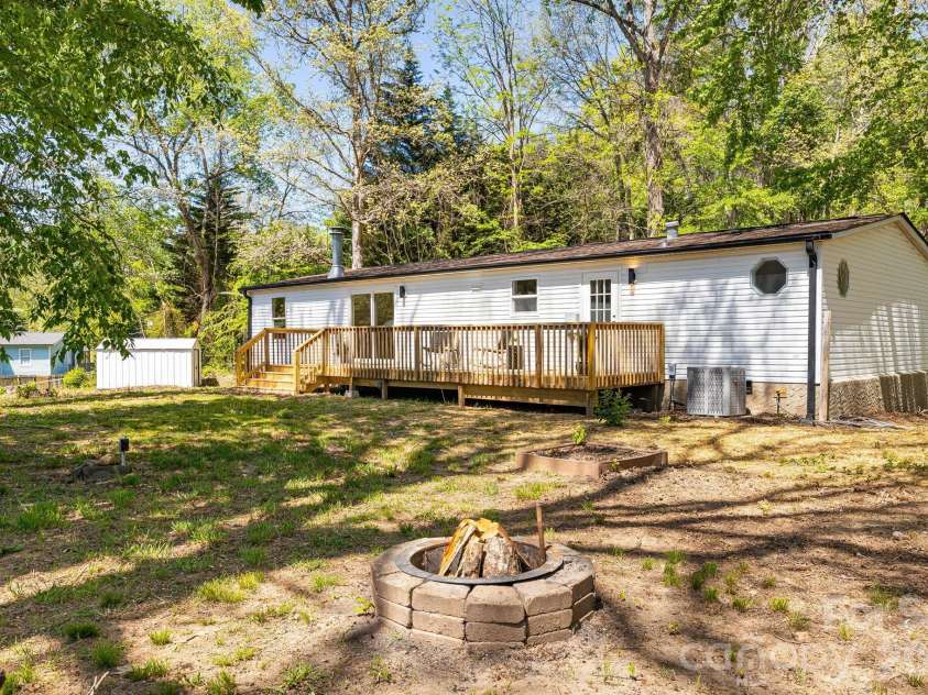 4 Woodscape Drive, Mills River, NC 28759.  MLS# CAR4372590, YatesRealty ID 23832. Level backyard with firepit