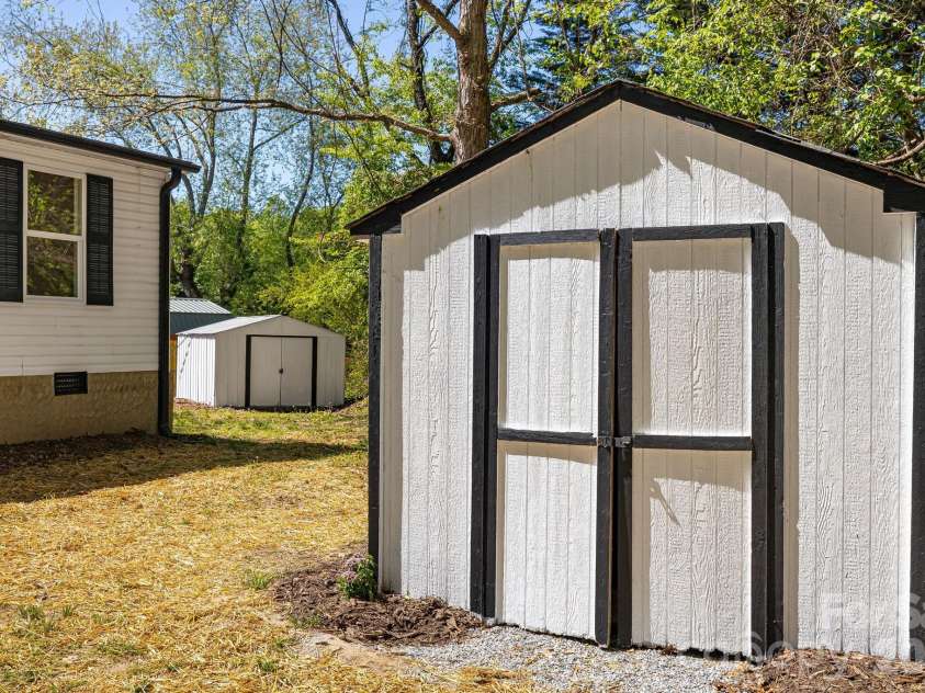 4 Woodscape Drive, Mills River, NC 28759.  MLS# CAR4372590, YatesRealty ID 23832. Two outdoor sheds provide ample storage for tools, hobbies, or recreational gear.