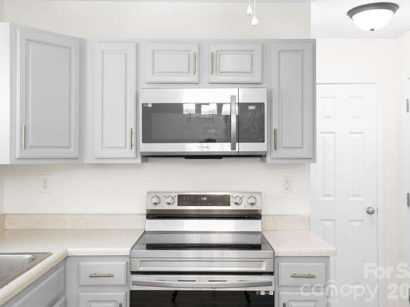 140 Thea Lane, Fletcher, NC 28732.  MLS# CAR4374845, YatesRealty ID 23837. Modern, updated hardware elevate the kitchen cabinets.