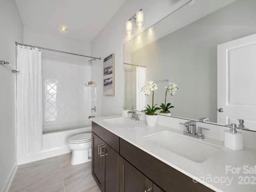 6022 Moonglade Lane, Charlotte, NC 28269.  MLS# CAR4315621, YatesRealty ID 2385. Photos are of a previously built Nayan Model home and are for illustrative purposes only. Design selections, finishes, and features may vary in the actual home.