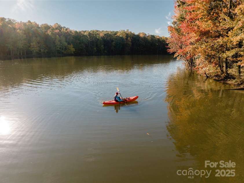 6022 Moonglade Lane, Charlotte, NC 28269.  MLS# CAR4315621, YatesRealty ID 2385. The 17-acre lake offers endless recreation—from kayaking and canoeing to peaceful catch-and-release fishing.