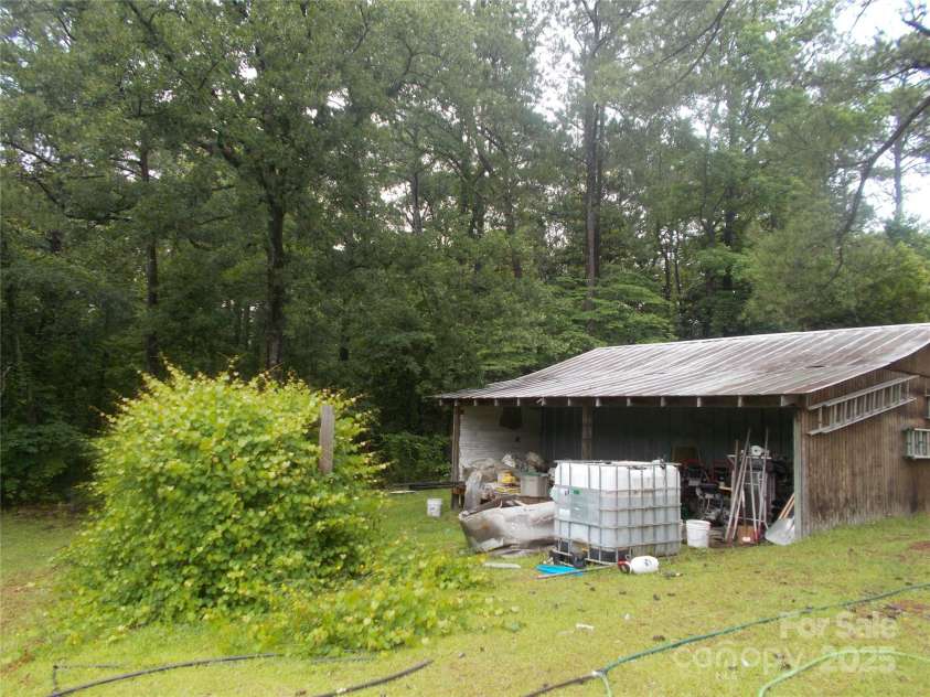 187 Cartledge Creek Road, Rockingham, NC 28379.  MLS# CAR4261307, YatesRealty ID 23852. Muscadine grapes & rear barn view