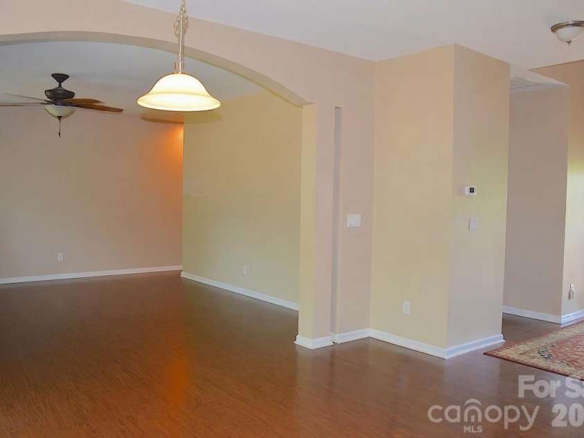 2007 Streamlet Way, Monroe, NC 28110.  MLS# CAR4376790, YatesRealty ID 23855. AI Staged Living Room / Dining Area