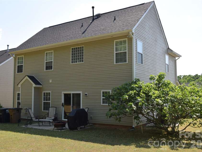 2007 Streamlet Way, Monroe, NC 28110.  MLS# CAR4376790, YatesRealty ID 23855. Back of home with fruiting fig tree.