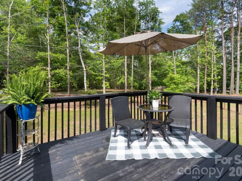 3860 Landrum Road, Columbus, NC 28722.  MLS# CAR4380844, YatesRealty ID 23865. Balcony from primary suite with access to the fenced back yard.