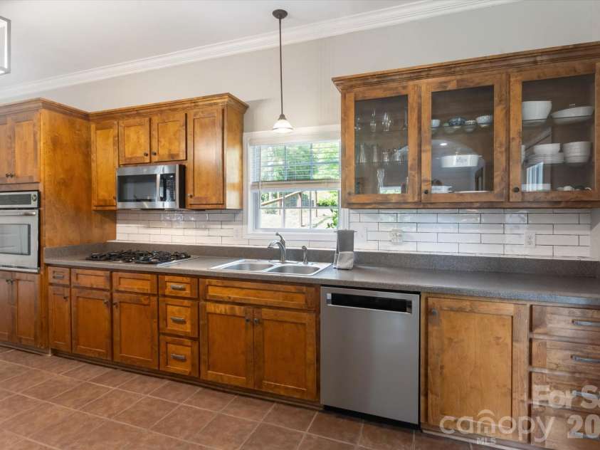 3860 Landrum Road, Columbus, NC 28722.  MLS# CAR4380844, YatesRealty ID 23865. Corian countertops and gorgeous wooden cabinets.