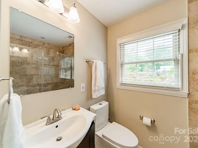 5522 Sharon Road, Charlotte, NC 28210.  MLS# CAR4251042, YatesRealty ID 23881. Hall Bathroom with seamless glass shower door.