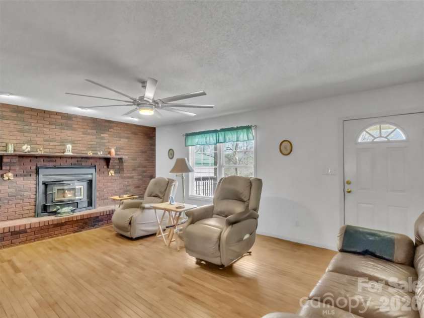 39 Millard Cove Road, Leicester, NC 28748.  MLS# CAR4355242, YatesRealty ID 23882. Living Room with wood insert