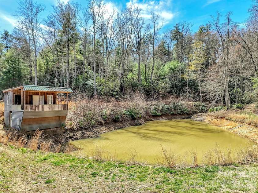39 Millard Cove Road, Leicester, NC 28748.  MLS# CAR4355242, YatesRealty ID 23882. Pond usually has more water/small cabin could be finished