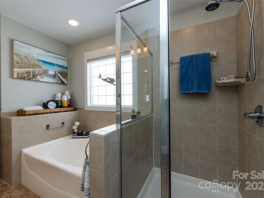 298 Bridges Farm Road, Mooresville, NC 28115.  MLS# CAR4273667, YatesRealty ID 23885. Tub and large, walk-in tiled shower