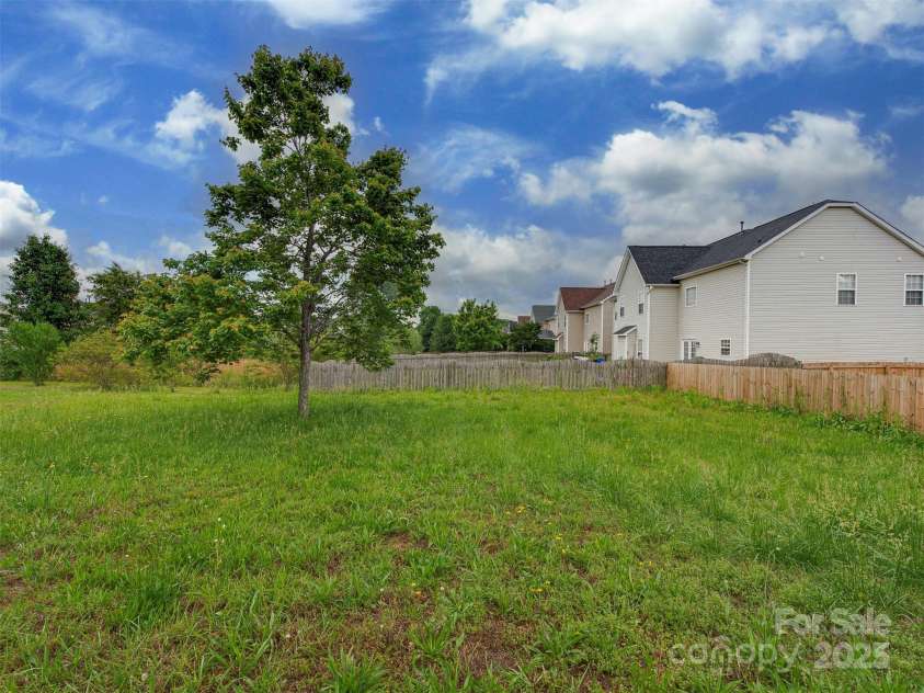 5607 Fulton Ridge Drive, Indian Trail, NC 28079.  MLS# CAR4259354, YatesRealty ID 23888. The backyard patio offers some privacy for barbecue and sitting. Imaging the possibilities ! widen the patio ? add brick extension or stamped concrete ? The backyard is large and long, it is also quite level (st