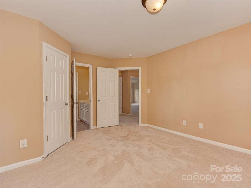 5607 Fulton Ridge Drive, Indian Trail, NC 28079.  MLS# CAR4259354, YatesRealty ID 23888. Upstairs, bedroom 1, on the left front of the house. the cameraman is looking towards the entrance of bedroom 1 (right open door). it is quite a nice bedroom size ! you can also see the jack and jill bathroom (s