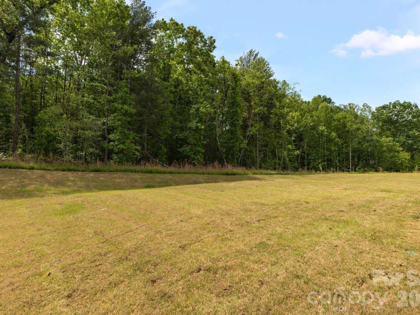 1334 37th Avenue Lane, Hickory, NC 28601.  MLS# CAR4373157, YatesRealty ID 23894. Trees line back yard offering nature and privacy