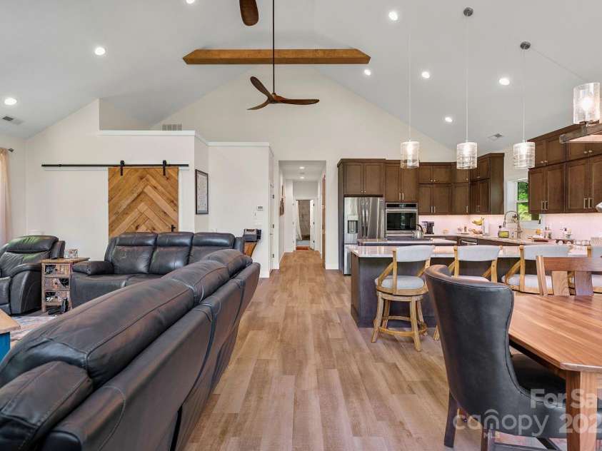 143 Burnside Trail, Hendersonville, NC 28792.  MLS# CAR4258291, YatesRealty ID 23895. Coat closet (left) with custom sliding door made from reclaimed wood on property.