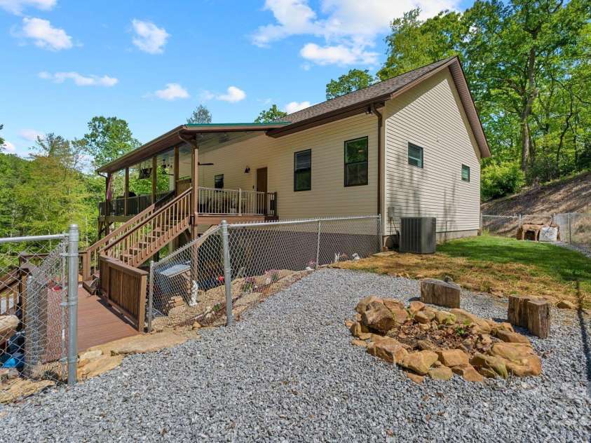 143 Burnside Trail, Hendersonville, NC 28792.  MLS# CAR4258291, YatesRealty ID 23895. Fenced back yard (currently serves as a dog run!) with fire pit